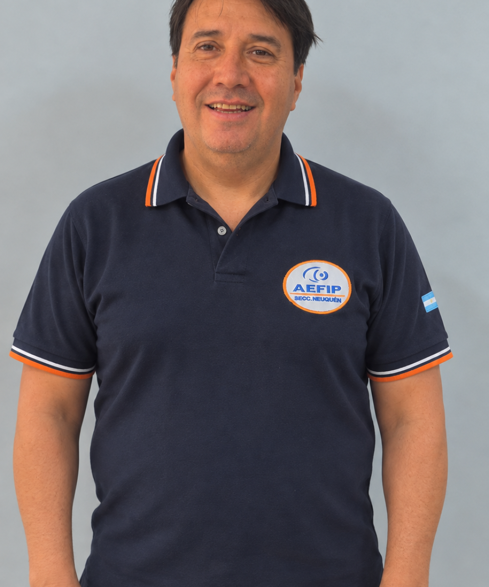 Retrato institucional con polo azul y parche AEFIP